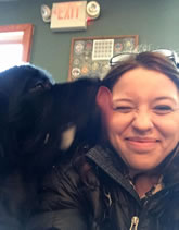 A dog licks an employee goodbye